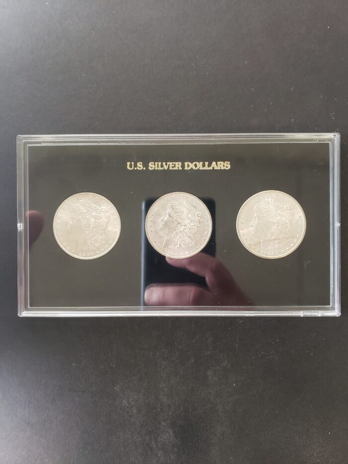 Three $1 Morgan Silver Dollars in a Plastic Holder